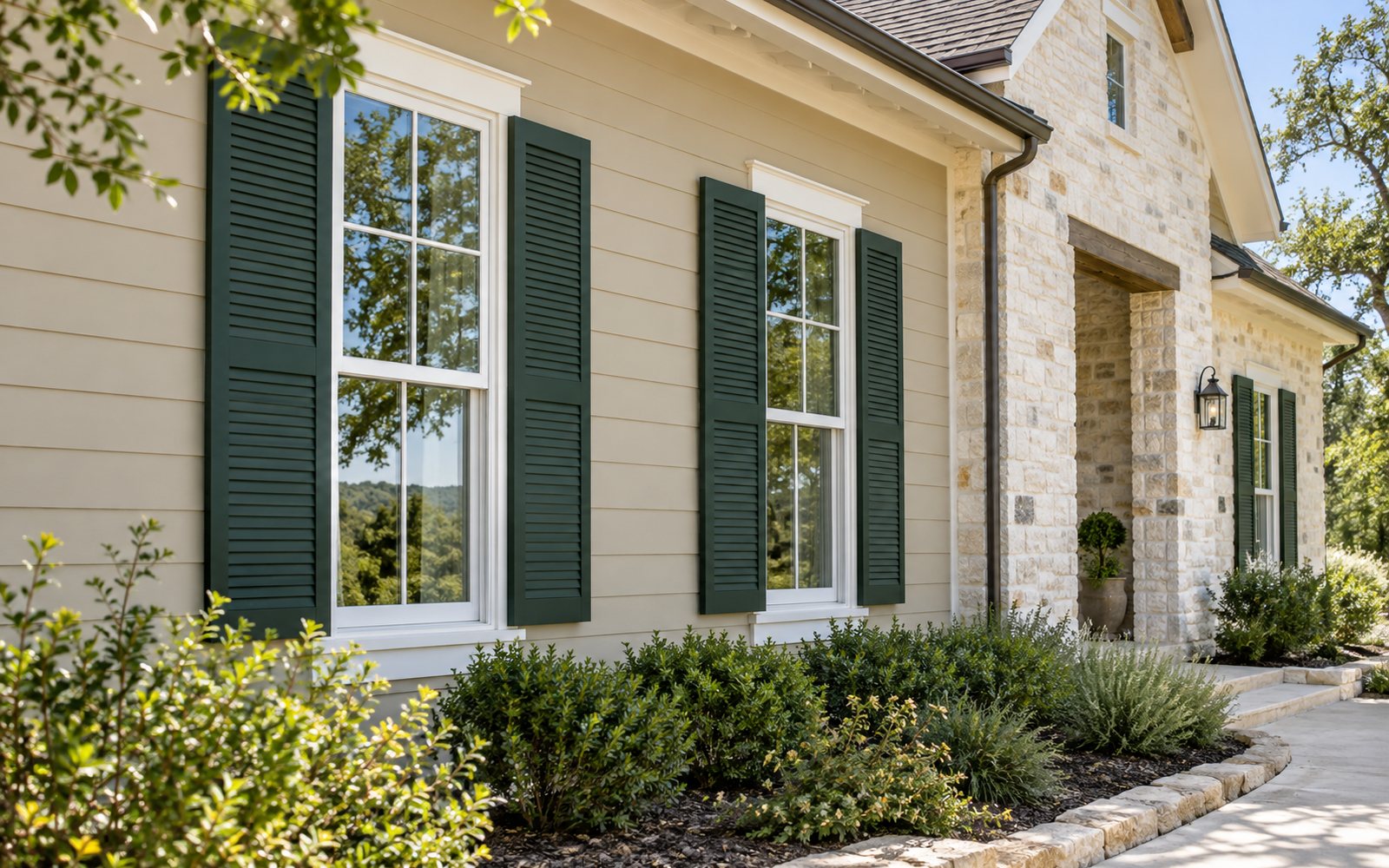 Freshly painted beige siding and green trim on a Texas Hill Country home